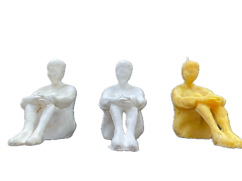 Plaster original shown together with two candle sculptures cast from the same form.