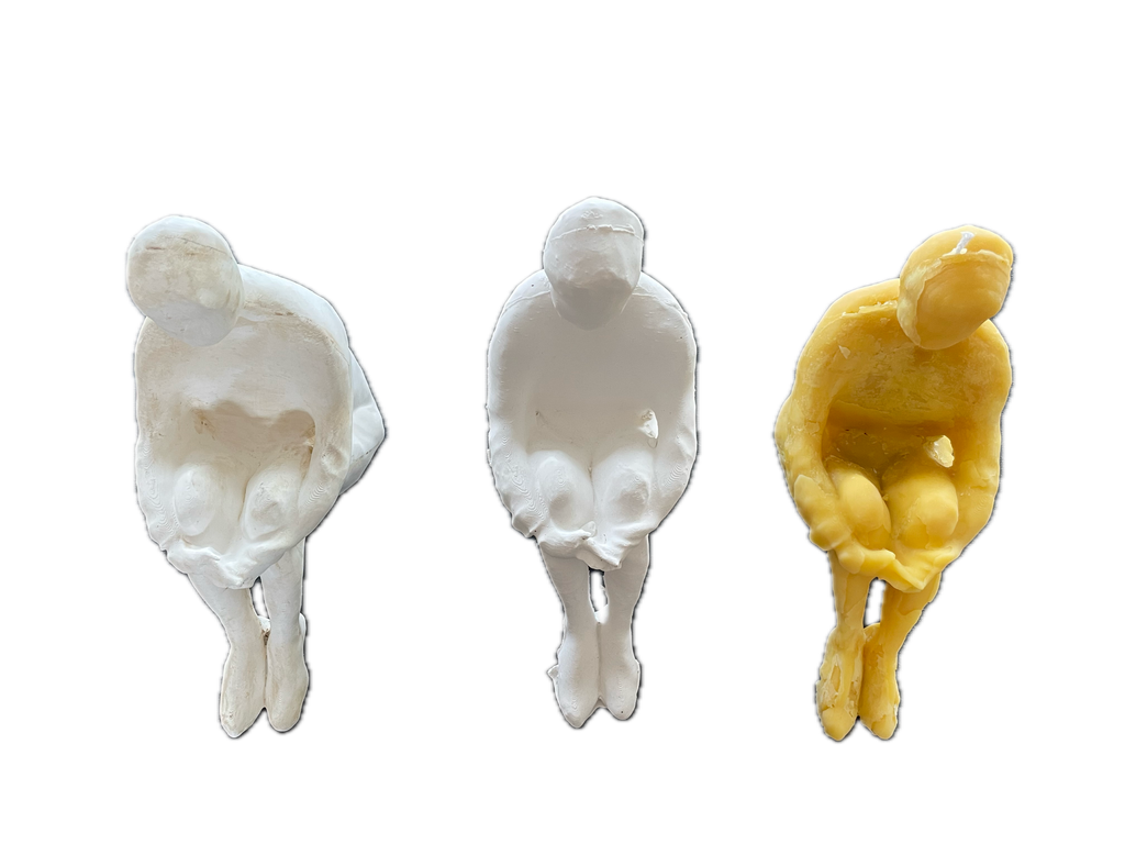 Plaster original shown together with two candle sculptures cast from the same form.
