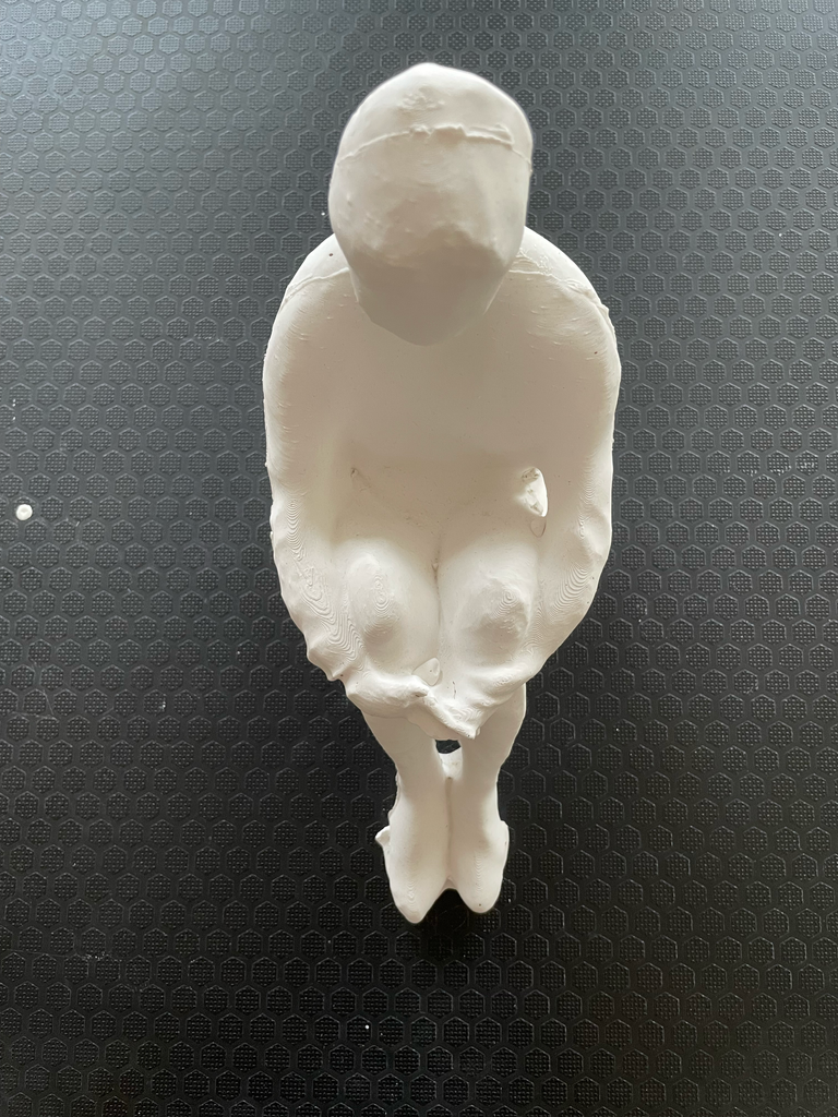 White candle sculpture cast from a figurative plaster original.