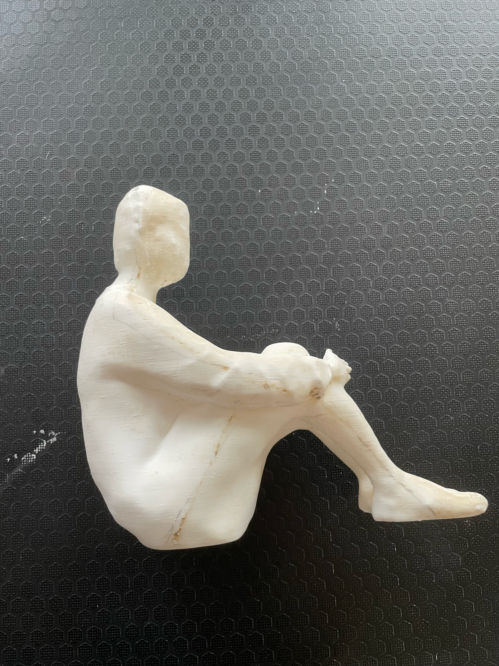White candle sculpture cast from a figurative plaster original.